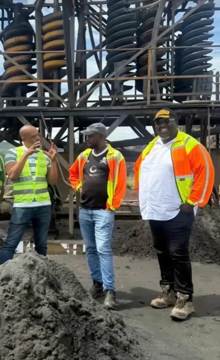 Large-scale mining operation with heavy equipment and industrial site infrastructure